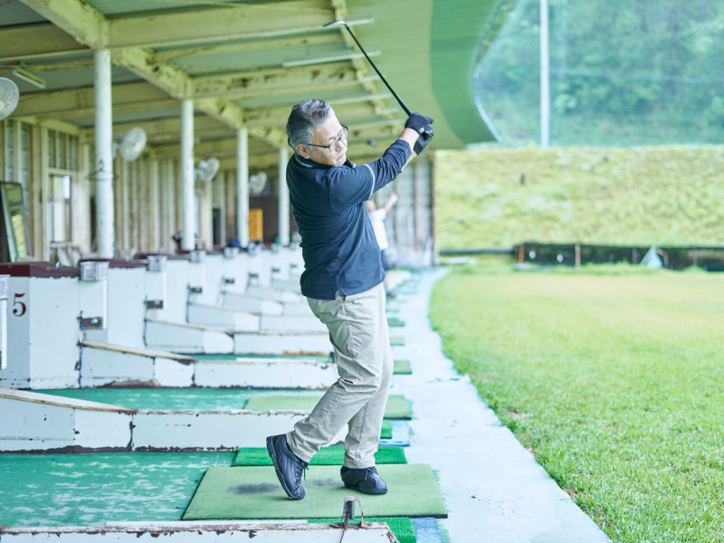 Senior golfer swinging a golf club